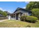 Charming blue home with a white porch, blooming flower baskets, and landscaped yard at 8268 Timberidge Ct, North Charleston, SC 29420