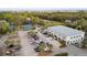Overhead view of a commercial building with parking, tennis court, golf course, and lovely trees at 856 Club Cottage Rd, Edisto Beach, SC 29438