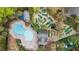 Aerial view of a community with a pool, mini golf, playground, and recreation areas for enjoyment at 856 Club Cottage Rd, Edisto Beach, SC 29438