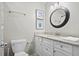 Bright bathroom featuring white cabinetry, granite counters, decorative wall art, and brushed nickel fixtures at 856 Club Cottage Rd, Edisto Beach, SC 29438