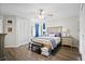 Comfortable primary bedroom with ensuite bath features ample closet space and natural light at 856 Club Cottage Rd, Edisto Beach, SC 29438