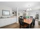 Bright, modern dining area open to living space with laminate floors and plenty of natural light at 856 Club Cottage Rd, Edisto Beach, SC 29438