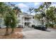 A bright, multi-story condo complex with mature trees and convenient parking in front at 856 Club Cottage Rd, Edisto Beach, SC 29438