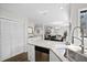 Open-concept kitchen with stainless steel appliances and pantry overlooking dining and living areas at 856 Club Cottage Rd, Edisto Beach, SC 29438