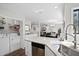 Open-concept kitchen with stainless steel appliances and laundry closet overlooking the living areas at 856 Club Cottage Rd, Edisto Beach, SC 29438