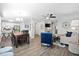 Open-concept view of the living room and dining area with modern furnishings and a sleek ceiling fan at 856 Club Cottage Rd, Edisto Beach, SC 29438