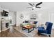 A stylish living room with gray walls, wood floors, modern furniture, and a decorative fireplace at 856 Club Cottage Rd, Edisto Beach, SC 29438