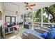 Cozy screened-in porch featuring comfortable seating, a swing, and a view of the backyard at 856 Club Cottage Rd, Edisto Beach, SC 29438