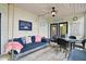 Enjoy outdoor living on this screened-in porch, complete with a swing, table, and comfortable seating at 856 Club Cottage Rd, Edisto Beach, SC 29438