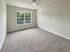 Empty carpeted bedroom featuring a ceiling fan and window at 982 Augustine Ct, Summerville, SC 29483