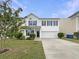 Charming two-story home featuring a well-manicured lawn, a two car garage, and classic black shutters at 982 Augustine Ct, Summerville, SC 29483