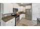 Modern kitchen featuring stainless steel appliances, granite countertops, and white cabinetry at 982 Augustine Ct, Summerville, SC 29483