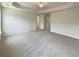 Spacious main bedroom featuring a tray ceiling, neutral carpet, and natural light at 982 Augustine Ct, Summerville, SC 29483