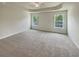 Large main bedroom featuring a tray ceiling, ceiling fan, neutral carpet, and natural light at 982 Augustine Ct, Summerville, SC 29483