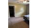 View of a bedroom with brown carpet, open door and bed frame at 10 Cranford Rd, Goose Creek, SC 29445