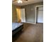 View of a bedroom with brown carpet, closet, open door and bed frame at 10 Cranford Rd, Goose Creek, SC 29445