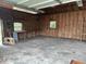 Spacious garage with concrete floors, wood-framed walls, and natural light from a window at 10 Cranford Rd, Goose Creek, SC 29445