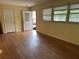 Living room with hardwood floors, door to outside, and natural light from a window at 10 Cranford Rd, Goose Creek, SC 29445