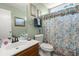 Bright bathroom featuring a floral shower curtain, vanity, toilet, and decorative accents at 102 Amberside Dr, Goose Creek, SC 29445