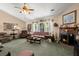 Inviting living room featuring carpeted floors and a warm brick fireplace at 102 Amberside Dr, Goose Creek, SC 29445