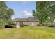 Lush backyard features a well-manicured lawn and mature landscaping and house exterior at 102 Bristol Ln, Goose Creek, SC 29445