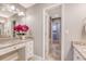 Bright bathroom featuring granite countertops, a vanity area, and a doorway leading to the laundry room at 102 Bristol Ln, Goose Creek, SC 29445