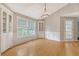 Corner dining room with hardwood flooring, built-in cabinets, and large window at 102 Bristol Ln, Goose Creek, SC 29445