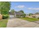 Suburban home with a large driveway, attached garage, and inviting front porch at 102 Bristol Ln, Goose Creek, SC 29445