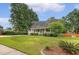 Lovely home with a well-manicured front lawn and cozy porch with verdant surroundings at 102 Bristol Ln, Goose Creek, SC 29445