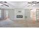 Inviting living room with fireplace, ceiling fans, and access to the entry and dining area at 102 Bristol Ln, Goose Creek, SC 29445