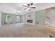 Bright, carpeted living room featuring a shiplap accent wall, fireplace, and dual ceiling fans at 102 Bristol Ln, Goose Creek, SC 29445