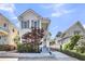 Charming two-story home with a covered porch, beautiful landscaping, and a driveway at 103 Fishburne St, Charleston, SC 29403