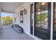 Charming front porch with gray floors and a black front door at 103 Fishburne St, Charleston, SC 29403