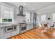 Bright kitchen with modern appliances, tile backsplash, and adjacent dining area at 103 Fishburne St, Charleston, SC 29403