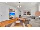 Cozy living room featuring hardwood floors, modern lighting, and comfortable seating at 103 Fishburne St, Charleston, SC 29403