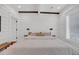 Cozy main bedroom with exposed beams, white wood paneling and natural light at 103 Fishburne St, Charleston, SC 29403