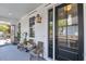 Inviting front porch features a dark front door, a seating bench, and outdoor lighting at 103 Fishburne St, Charleston, SC 29403