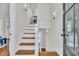 A bright staircase featuring hardwood treads, white risers, and modern lighting at 103 Fishburne St, Charleston, SC 29403