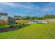 Spacious backyard features a pool, storage shed, beautiful green grass and wooden fence at 107 Tandil Ct, Summerville, SC 29483