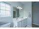 Bright bathroom with dual sinks, white cabinetry, and a large mirror reflecting natural light at 107 Tandil Ct, Summerville, SC 29483