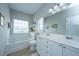 Relaxing bathroom with a soaking tub, dual vanity, and natural light from a large window at 107 Tandil Ct, Summerville, SC 29483
