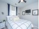 Comfortable bedroom featuring a plush bed with patterned bedding, bedside table, and mounted TV at 107 Tandil Ct, Summerville, SC 29483