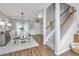 Bright, open dining room featuring modern light fixture, wood floors, and easy access to the staircase and front door at 107 Tandil Ct, Summerville, SC 29483