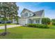 Two-story home featuring manicured lawn, tidy landscaping, and an attached two-car garage at 107 Tandil Ct, Summerville, SC 29483