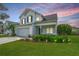 Charming two-story home featuring a manicured lawn, tidy landscaping, and an attached two-car garage at 107 Tandil Ct, Summerville, SC 29483
