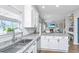 Bright kitchen with white cabinets, granite countertops, stainless steel appliances, and an island with seating at 107 Tandil Ct, Summerville, SC 29483