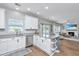 Bright, open kitchen with white cabinets, stainless steel appliances, and seamless flow to the living room at 107 Tandil Ct, Summerville, SC 29483