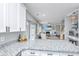 Open kitchen with white cabinets, granite countertops, stainless steel appliances, and a seamless flow to the living area at 107 Tandil Ct, Summerville, SC 29483