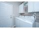 Well-equipped laundry room with modern washer and dryer, storage cabinets, and stylish wall accents at 107 Tandil Ct, Summerville, SC 29483