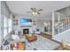 Comfortable living room with fireplace, large screen TV, cozy sofa, ceiling fan, and staircase access at 107 Tandil Ct, Summerville, SC 29483